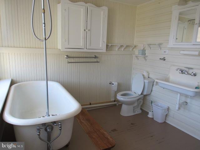 bathroom featuring wood-type flooring and toilet