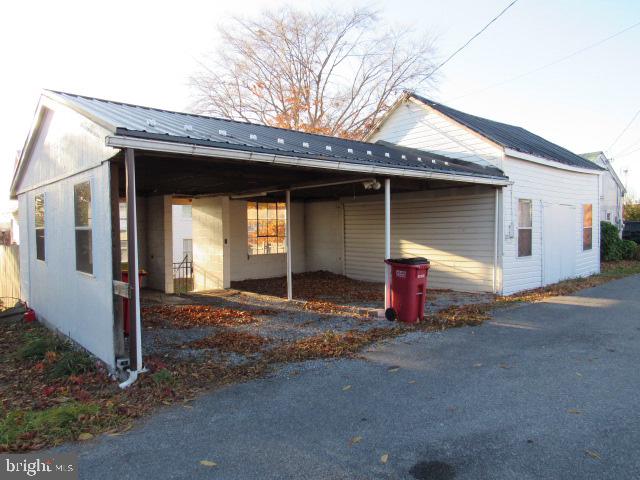 view of property exterior with a carport