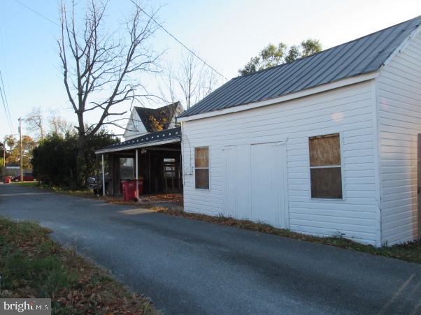 view of property exterior with a carport