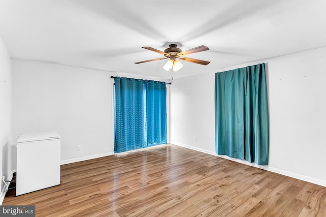 empty room featuring ceiling fan and wood-type flooring