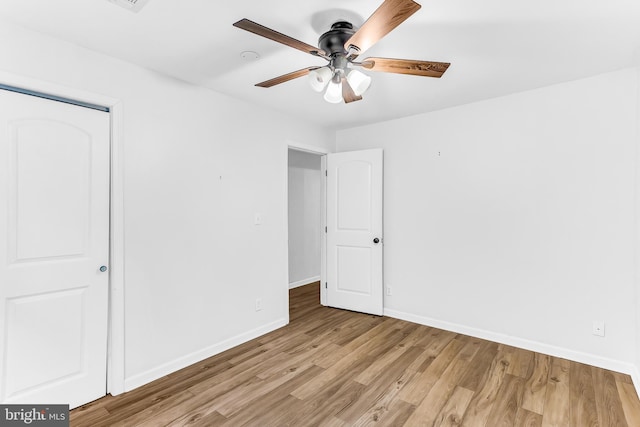 unfurnished bedroom with a closet, light hardwood / wood-style floors, and ceiling fan