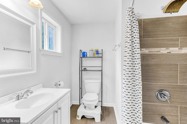 bathroom with wood-type flooring, vanity, and toilet