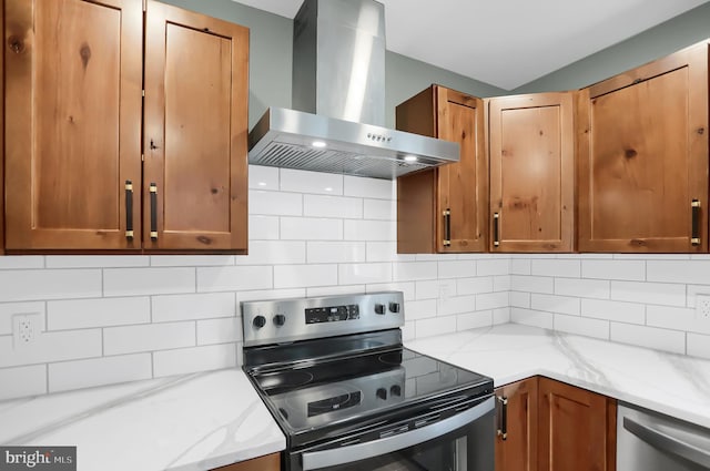 kitchen with appliances with stainless steel finishes, tasteful backsplash, and wall chimney exhaust hood