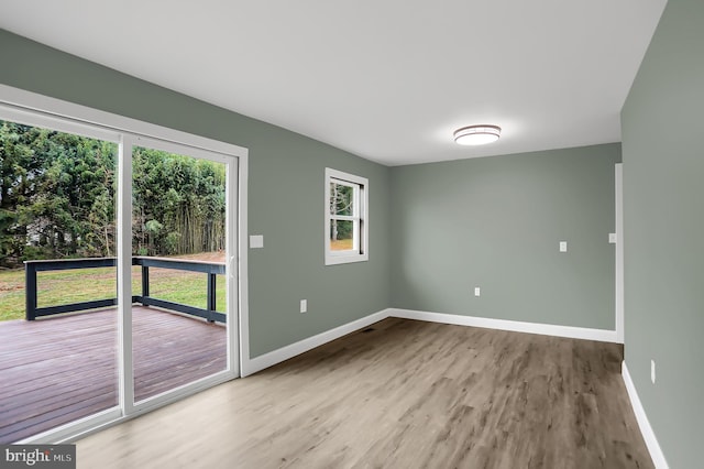 unfurnished room with light wood-type flooring