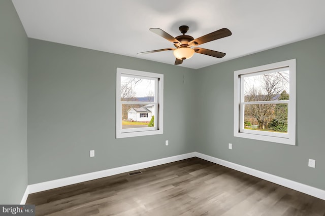 spare room with hardwood / wood-style flooring and ceiling fan