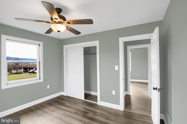 unfurnished bedroom with a closet, ceiling fan, and hardwood / wood-style floors