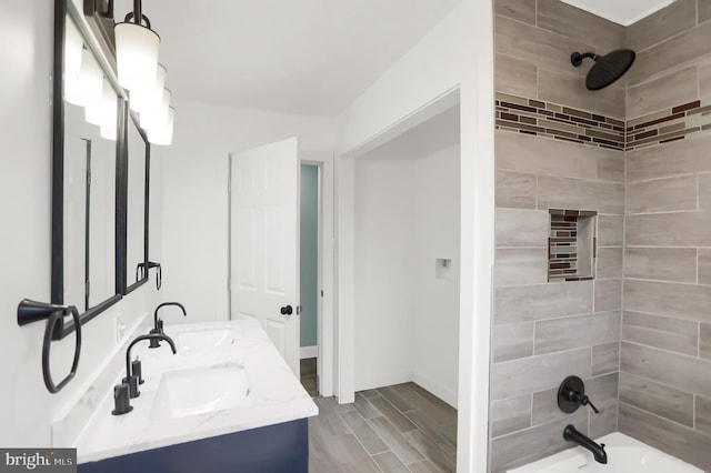 bathroom with vanity and tiled shower / bath