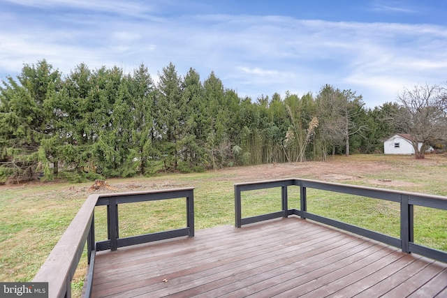 wooden deck featuring a storage unit and a yard