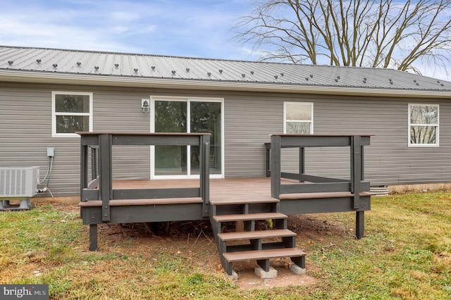 back of house with cooling unit, a deck, and a yard