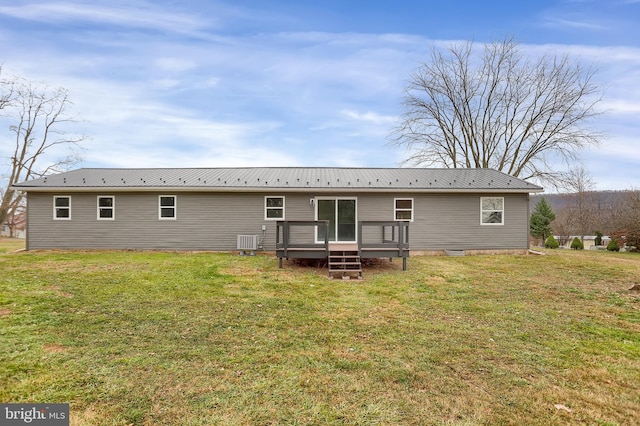 rear view of house with central AC, a yard, and a deck