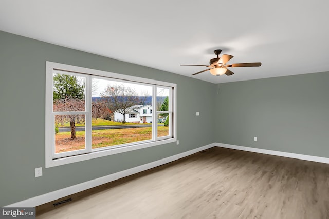 empty room featuring hardwood / wood-style flooring and ceiling fan