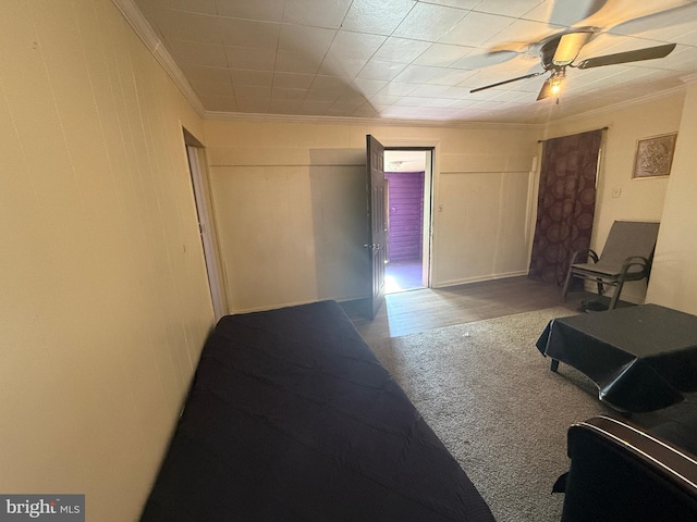 interior space featuring crown molding, hardwood / wood-style flooring, and ceiling fan