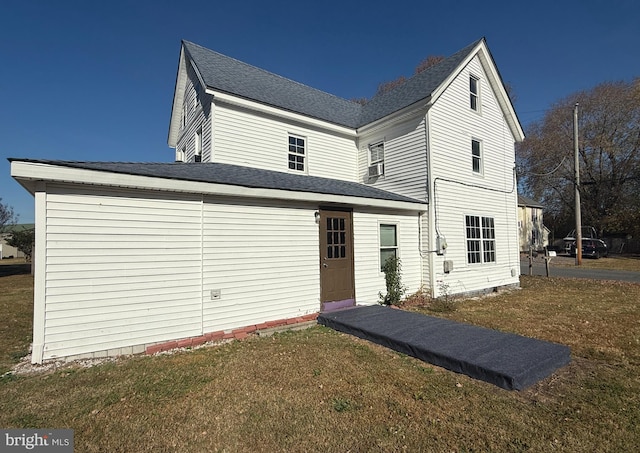 back of house with a lawn