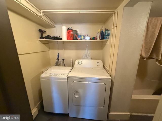 clothes washing area with washing machine and dryer