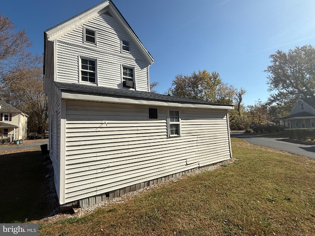 view of side of home with a yard