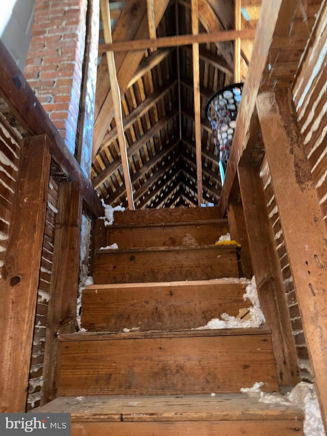 stairs featuring vaulted ceiling