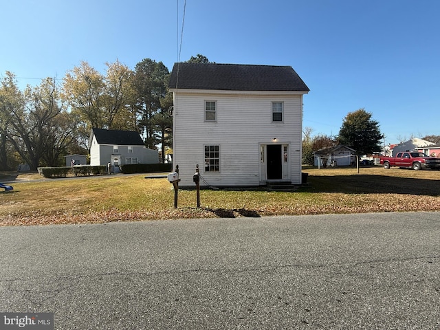 view of side of property with a lawn