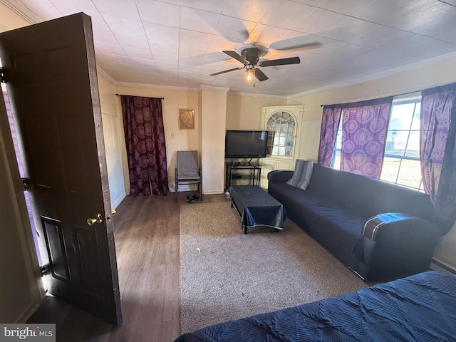 living room with crown molding, wood-type flooring, and ceiling fan