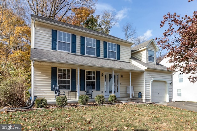 view of front facade featuring a garage, a porch, and a front yard