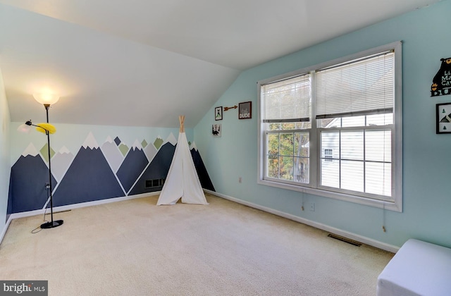 rec room featuring lofted ceiling and carpet