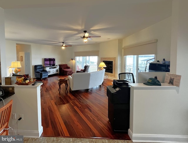 living room with dark hardwood / wood-style floors and a healthy amount of sunlight