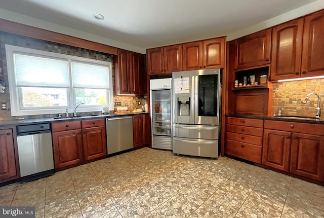 kitchen with sink, backsplash, beverage cooler, and stainless steel appliances