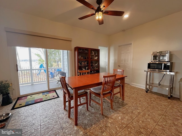 dining area with light tile patterned floors and ceiling fan