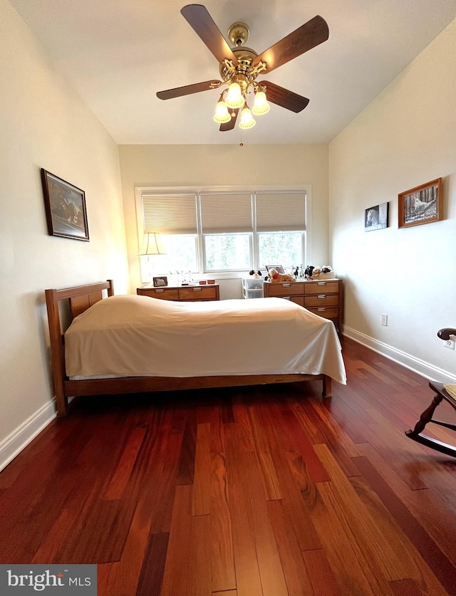 bedroom featuring ceiling fan and dark hardwood / wood-style floors