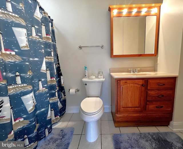 bathroom with tile patterned flooring, vanity, and toilet