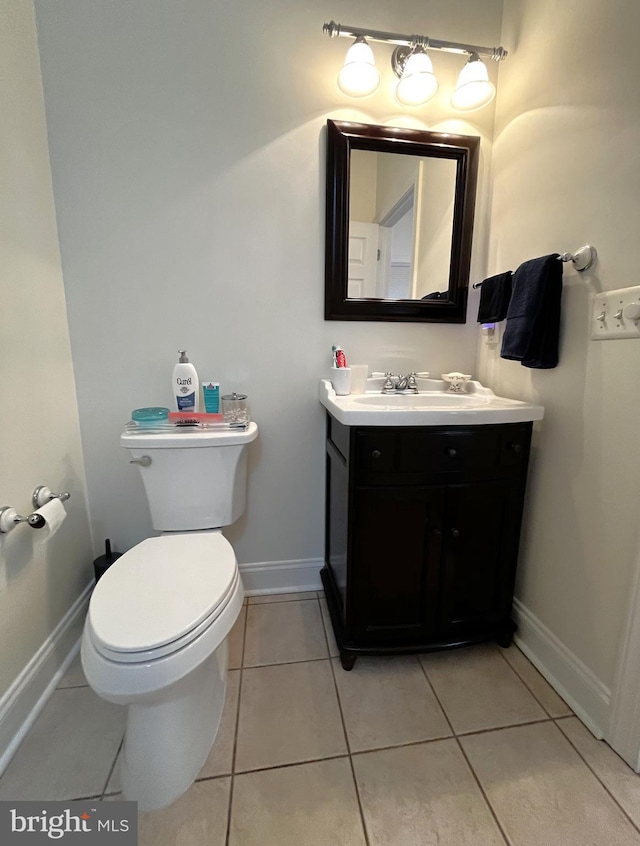 bathroom featuring tile patterned floors, toilet, and vanity