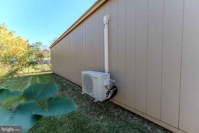 view of property exterior featuring ac unit and a lawn