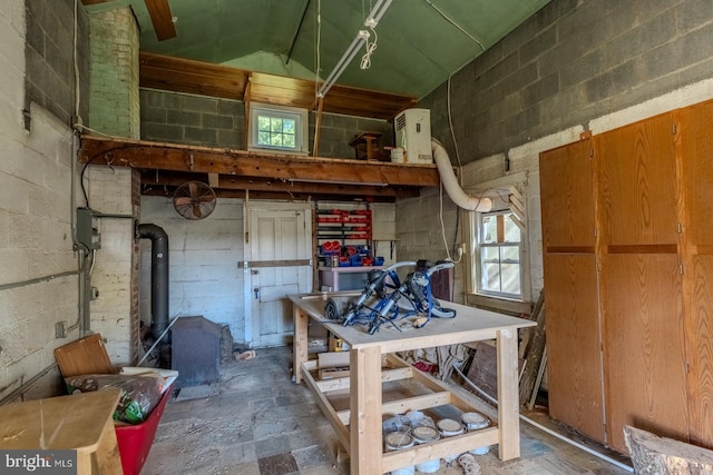 interior space with a wood stove and lofted ceiling