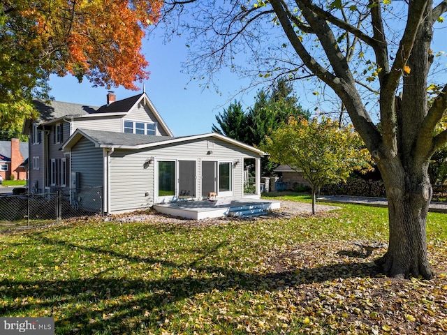 rear view of property with a patio area and a lawn