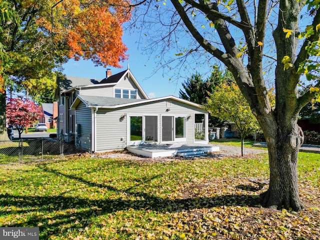 back of property featuring a yard