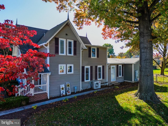 view of front facade with a front lawn and ac unit