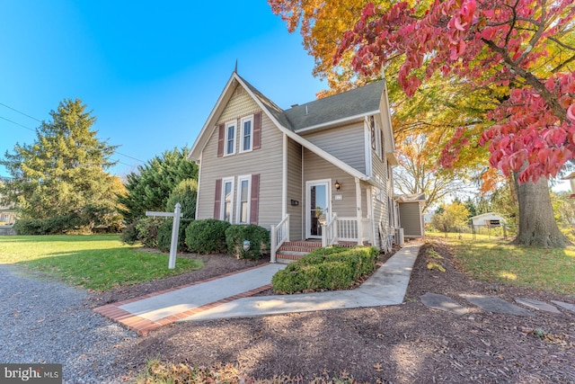 front facade featuring a porch and a front lawn