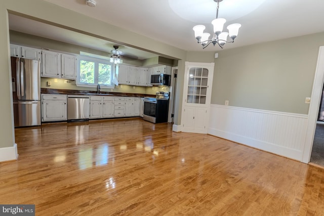 kitchen featuring light hardwood / wood-style floors, stainless steel appliances, and sink