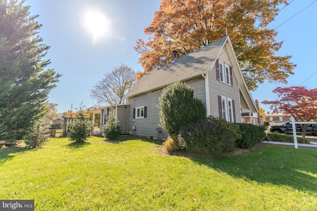 view of side of home featuring a lawn