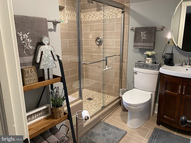 bathroom with vanity, toilet, and an enclosed shower