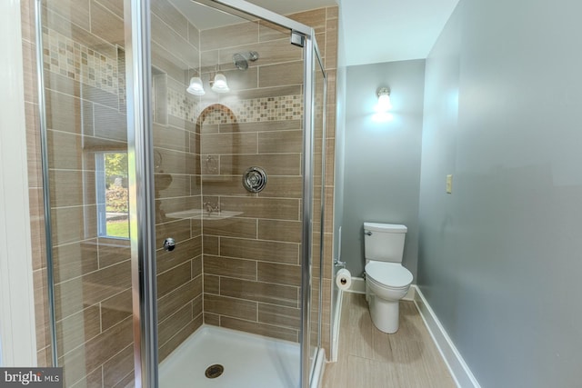 bathroom with toilet and walk in shower