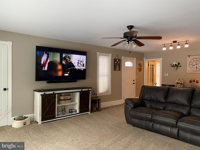 carpeted living room with ceiling fan