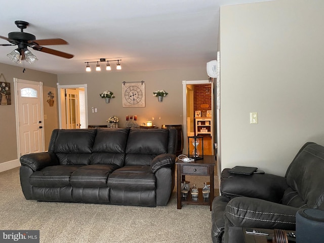 carpeted living room with an AC wall unit and ceiling fan