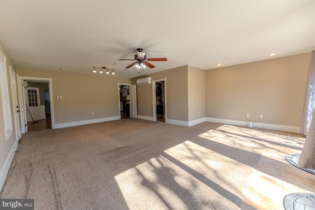 unfurnished living room with light carpet, a wall unit AC, and ceiling fan