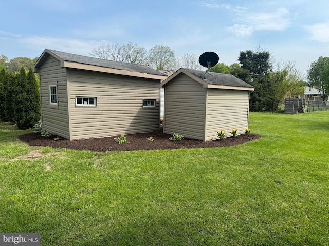 exterior space with a storage shed and a lawn