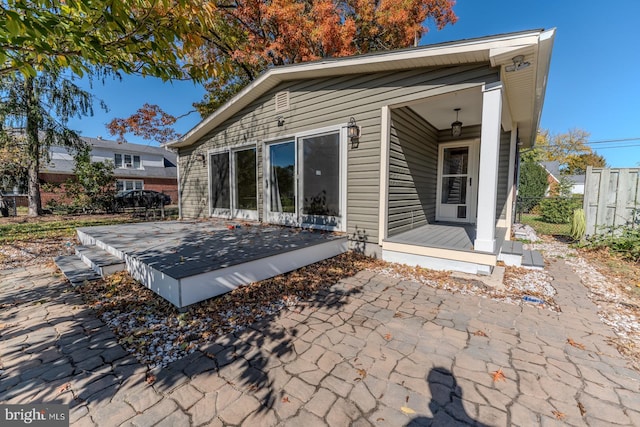 back of house featuring a patio and a porch