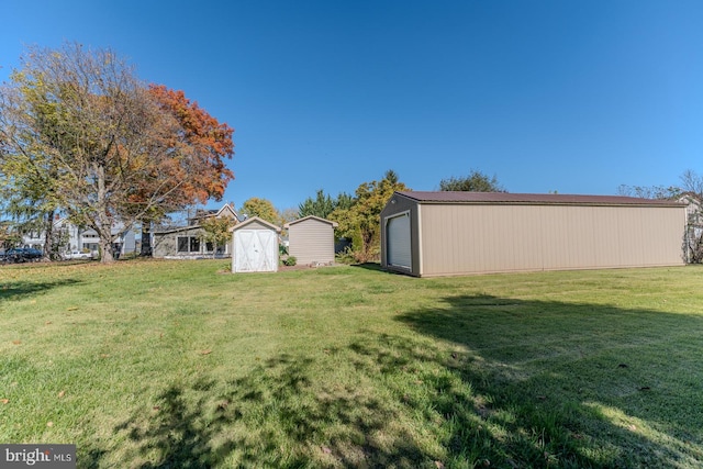 view of yard with a storage unit and a garage