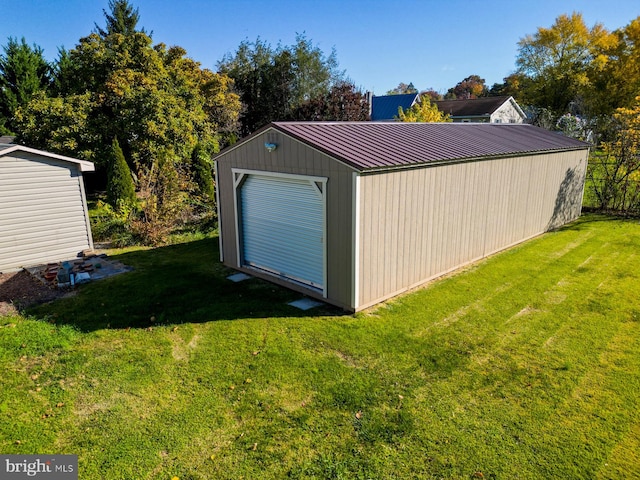 view of outbuilding featuring a yard and a garage