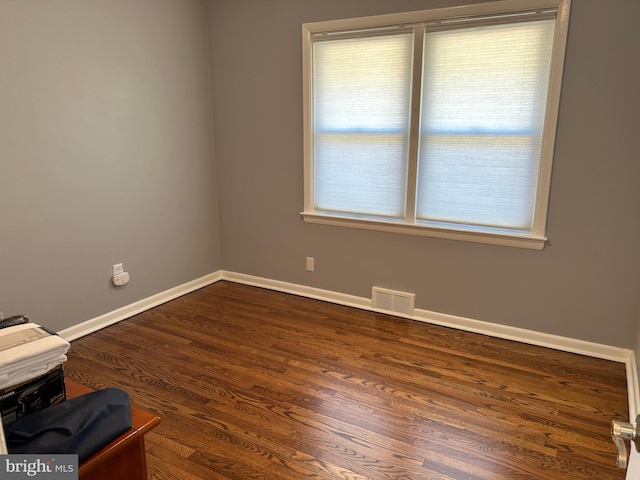 empty room with dark wood-type flooring