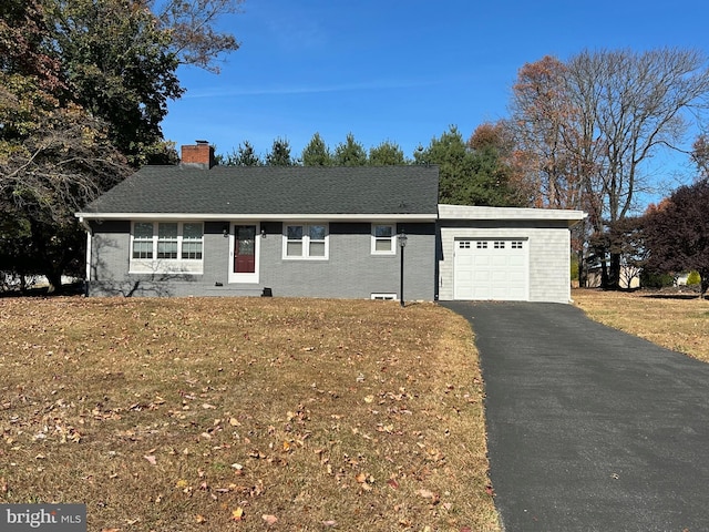 single story home featuring a garage and a front yard