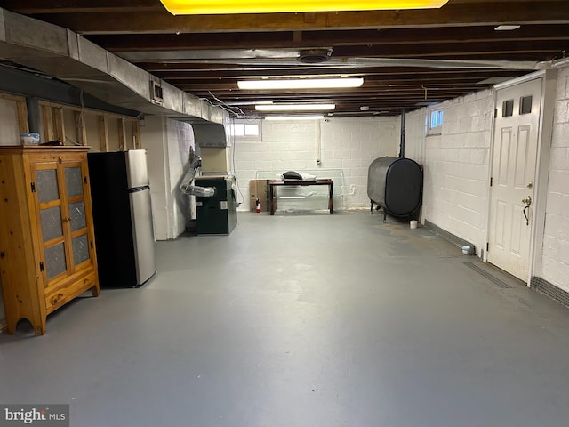 basement with stainless steel fridge